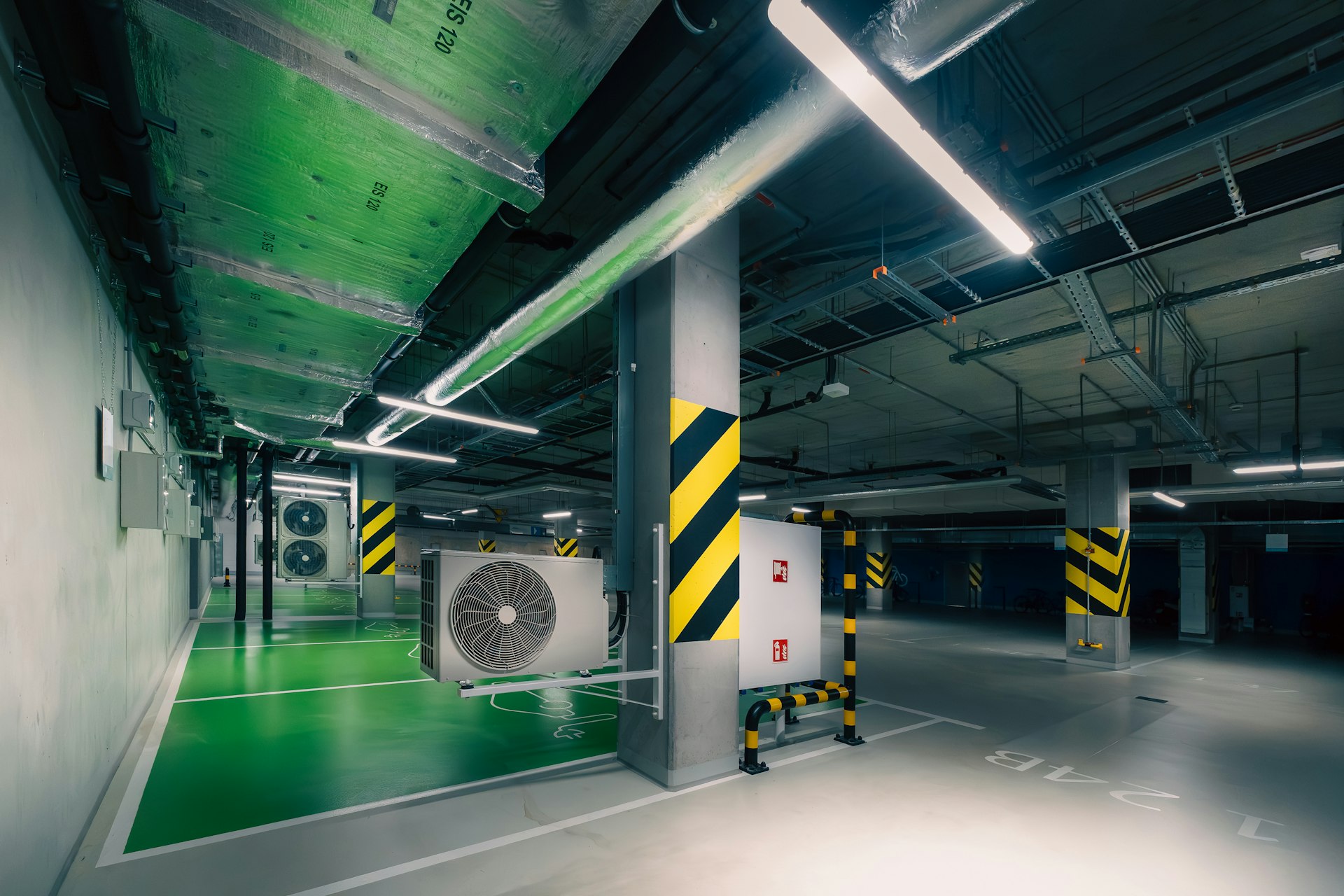 Modern parking garage interior with ventilation systems.